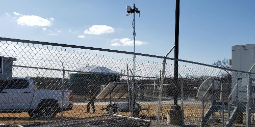 Solar Surveillance Trailer Behind Fence - Wide Thumb