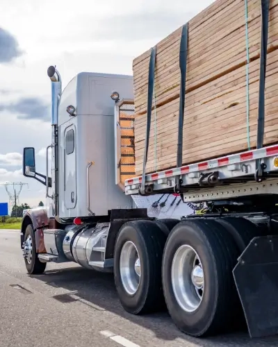 Blog Thumbnail Tall timber materials on back of a lorry