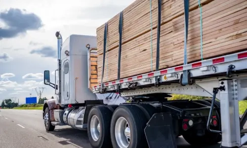 Blog Thumbnail Wide timber materials on back of a lorry