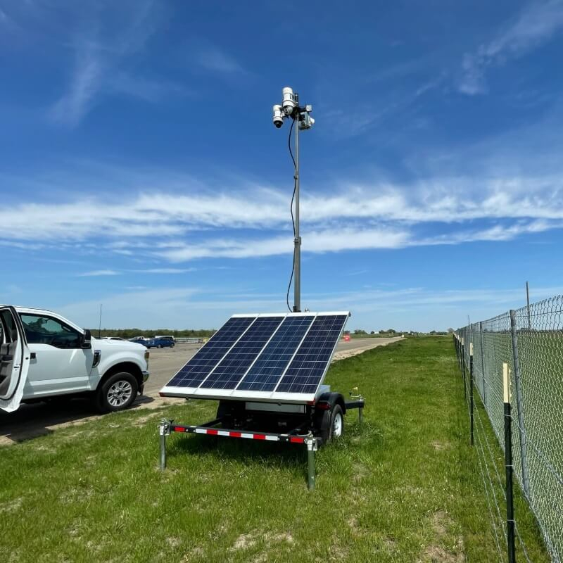 WCCTV Portable Solar Surveillance Trailer By Chain Link Fence